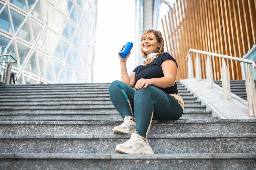 Plus,Size,Woman,Having,A,Break,During,Her,Workout,,Curvy